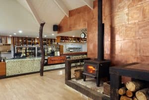 Awaroa Lodge main bar and fireplace