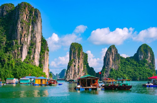 <em>Floating fishing village and rock island in Halong Bay, Vietnam</em>