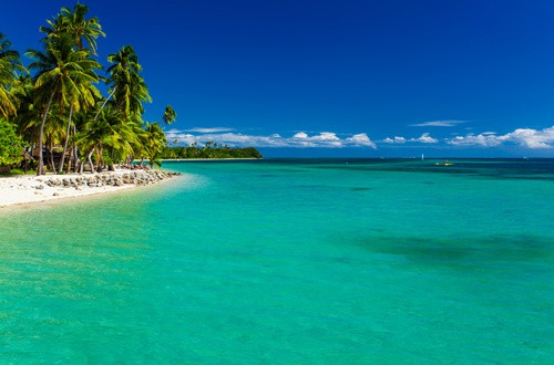 <em>Tropical island in Fiji with sandy beach and pristine water</em>