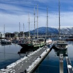 Signature Voyage Norway Hurtigruten MS Trollfjord sailing past snow-covered Norwegian coastline