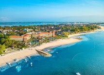aerial view of a beachfront resort with pools and tropical gardens in Bali