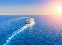 A cruise ship in open water during sunset
