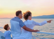 family looking out at the sea on a cruise