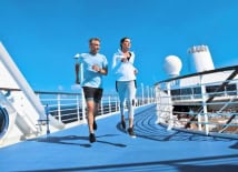 couple running on cruise ship athletic track