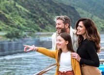 Family looking out to historic sites on a European river cruise