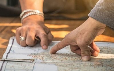 two hands point on the map