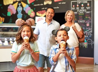 Two kids and two parents in an ice cream shop in Disneyland